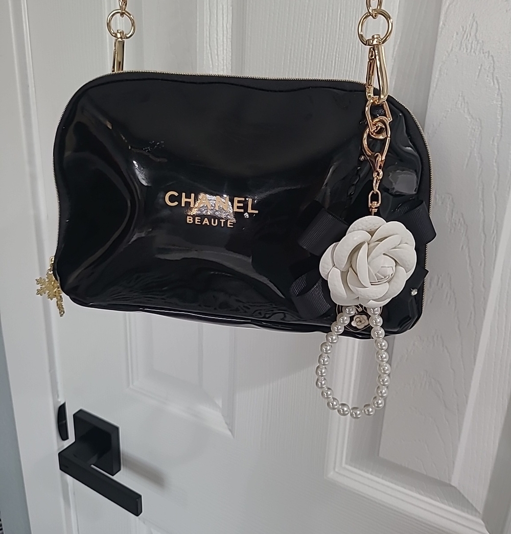 Black Patent Crossbody Bag with Floral Charm CHANEL BEAUTE